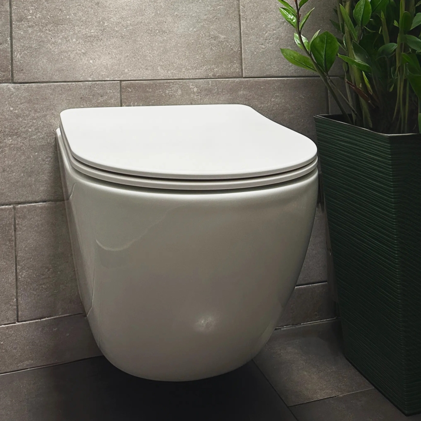 REA-C1259 - Pakabinamas unitazas su sėdyne CARLO MINI TORNADO RIMLESS keramika / blizgi balta